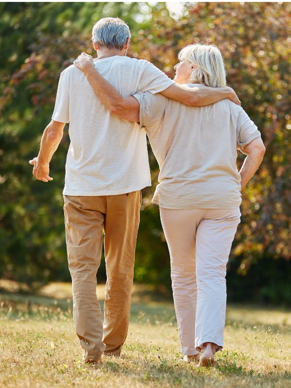 Retirees walking arm in arm